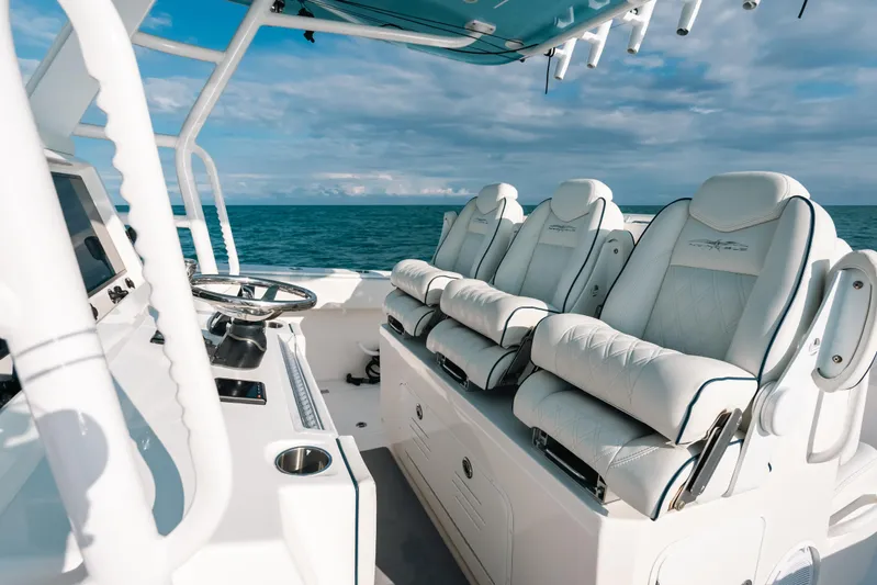  Yacht Photos Pics Luxurious seating on 2021 Invincible 37 Catamaran, featuring sleek design and ocean backdrop.