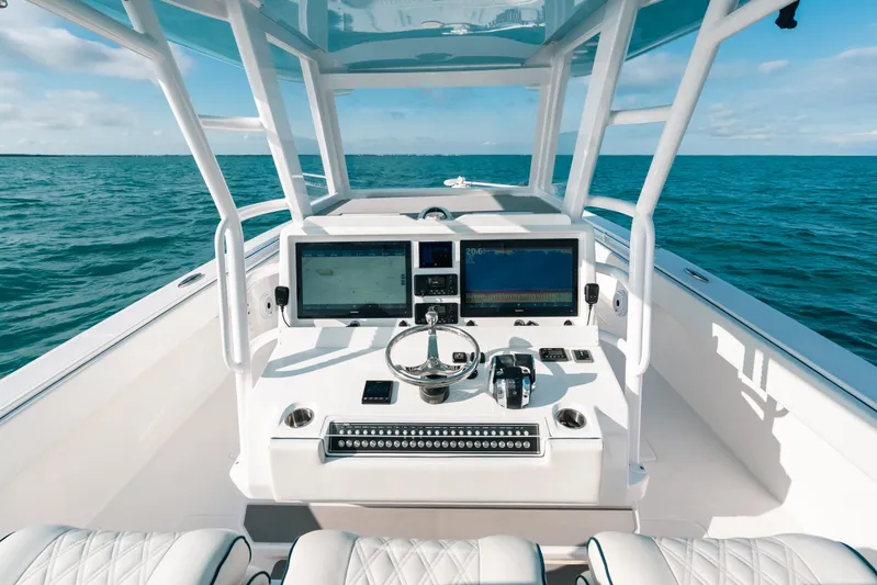  Yacht Photos Pics 2021 Invincible 37 Catamaran helm with dual screens on open ocean.
