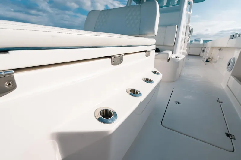  Yacht Photos Pics 2021 Invincible 37 Catamaran interior with seating and rod holders, under a clear sky.