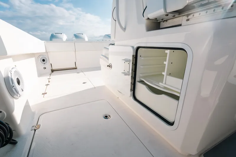  Yacht Photos Pics 2021 Invincible 37 Catamaran deck with storage compartment and seating, under a clear sky.