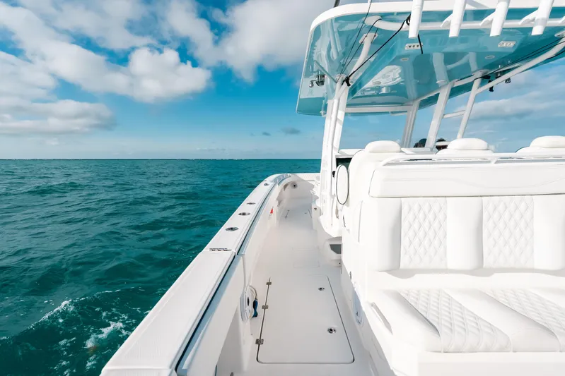  Yacht Photos Pics Invincible 37 Catamaran 2021 cruising on open ocean under clear blue sky.