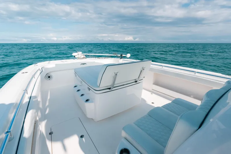  Yacht Photos Pics Invincible 37 Catamaran 2021 on open sea, featuring sleek white seating and clear blue waters.