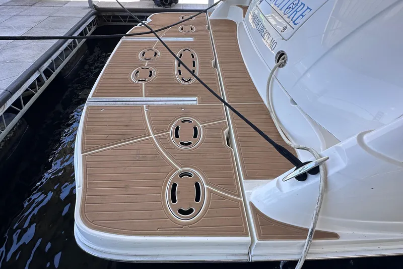  Yacht Photos Pics 2005 Sea Ray 48 Sundancer swim platform with teak-style decking at a marina.