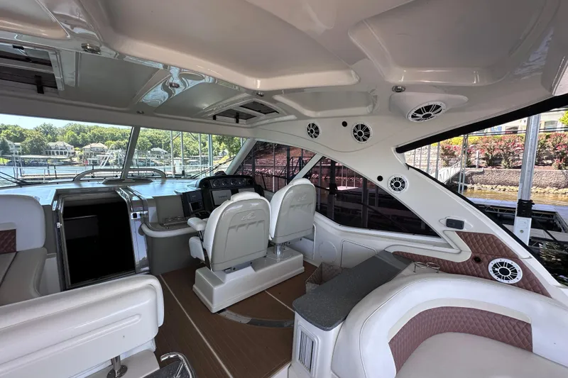 Yacht Photos Pics Luxurious 2005 Sea Ray 48 Sundancer yacht interior with helm and seating area.