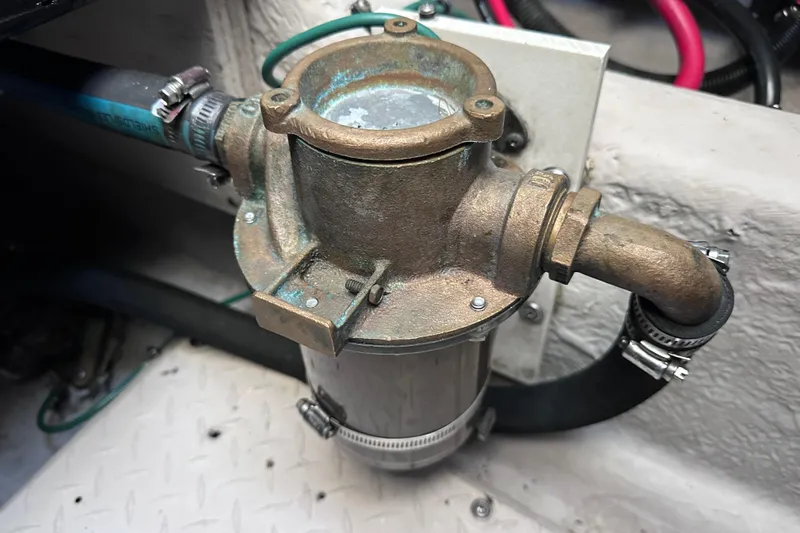  Yacht Photos Pics Engine component of 2005 Sea Ray 48 Sundancer boat, featuring metal piping and clamps.