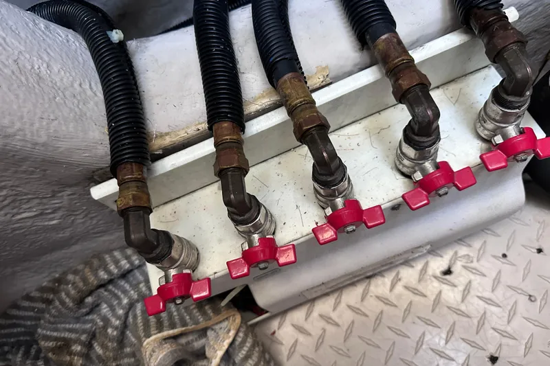  Yacht Photos Pics Close-up of 2005 Sea Ray 48 Sundancer engine valves with red handles and black hoses.