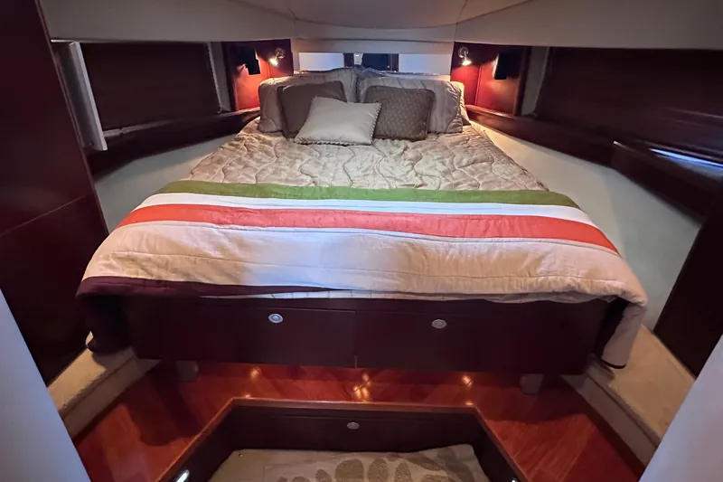  Yacht Photos Pics Luxurious bedroom interior of 2005 Sea Ray 48 Sundancer yacht with cozy bedding.