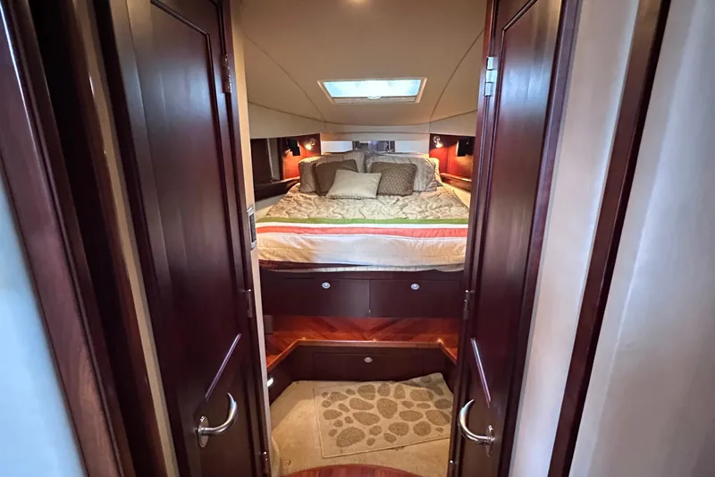  Yacht Photos Pics Luxurious cabin interior of 2005 Sea Ray 48 Sundancer yacht with cozy bedding.