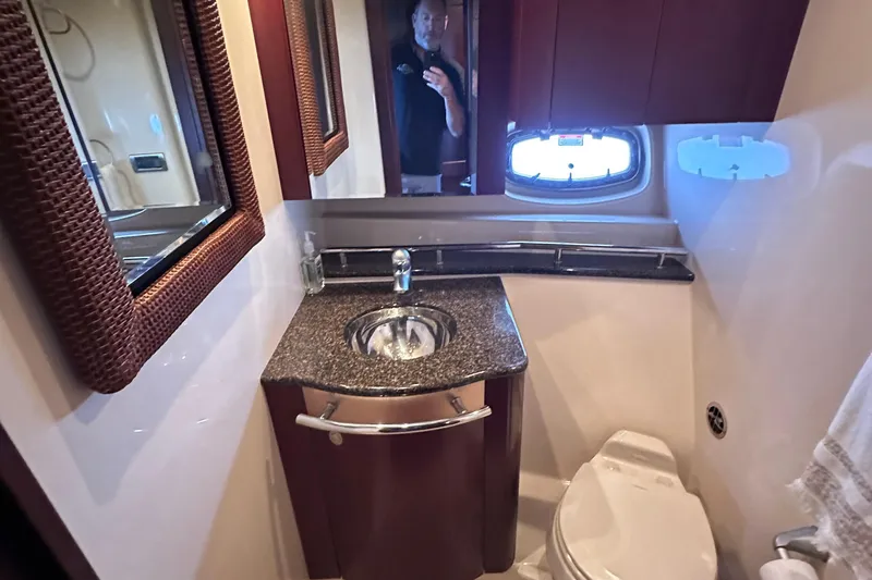  Yacht Photos Pics Luxurious bathroom in 2005 Sea Ray 48 Sundancer yacht with granite countertop and modern fixtures.