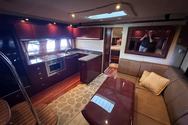  Yacht Photos Pics Luxurious interior of 2005 Sea Ray 48 Sundancer yacht with kitchen and seating area.