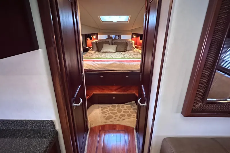  Yacht Photos Pics Luxurious 2005 Sea Ray 48 Sundancer cabin interior with cozy bed and elegant wood finishes.