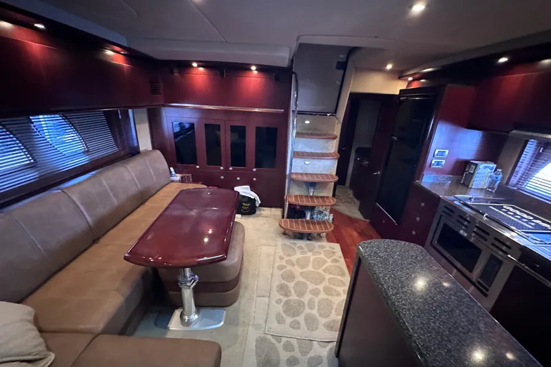  Yacht Photos Pics Luxurious interior of 2005 Sea Ray 48 Sundancer yacht with elegant seating and modern kitchen.
