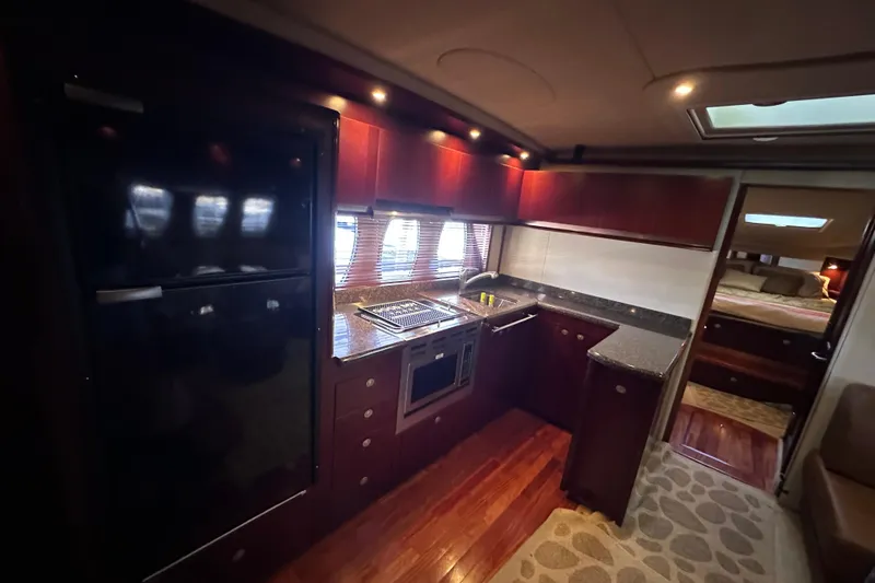  Yacht Photos Pics Luxurious kitchen interior of 2005 Sea Ray 48 Sundancer yacht with modern amenities.