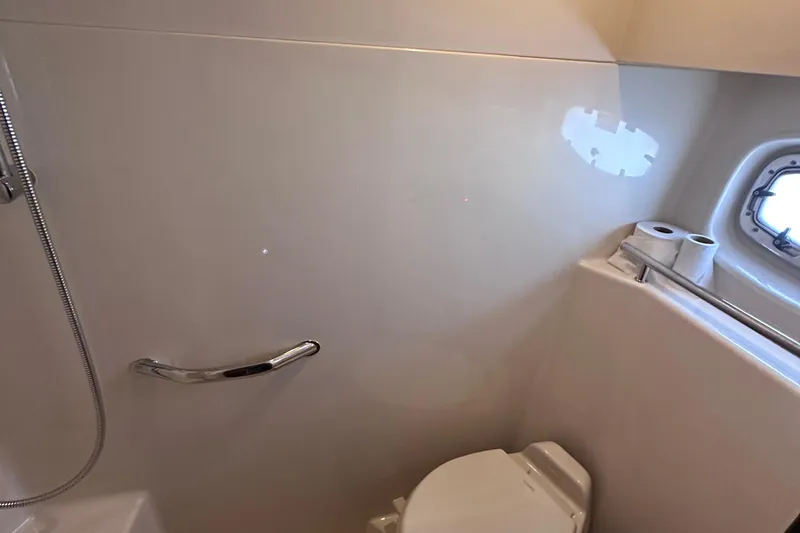  Yacht Photos Pics Bathroom interior of 2005 Sea Ray 48 Sundancer yacht with toilet and porthole.