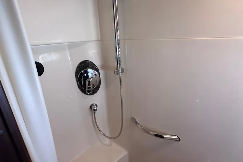  Yacht Photos Pics Shower area in 2005 Sea Ray 48 Sundancer yacht, featuring chrome fixtures and white walls.