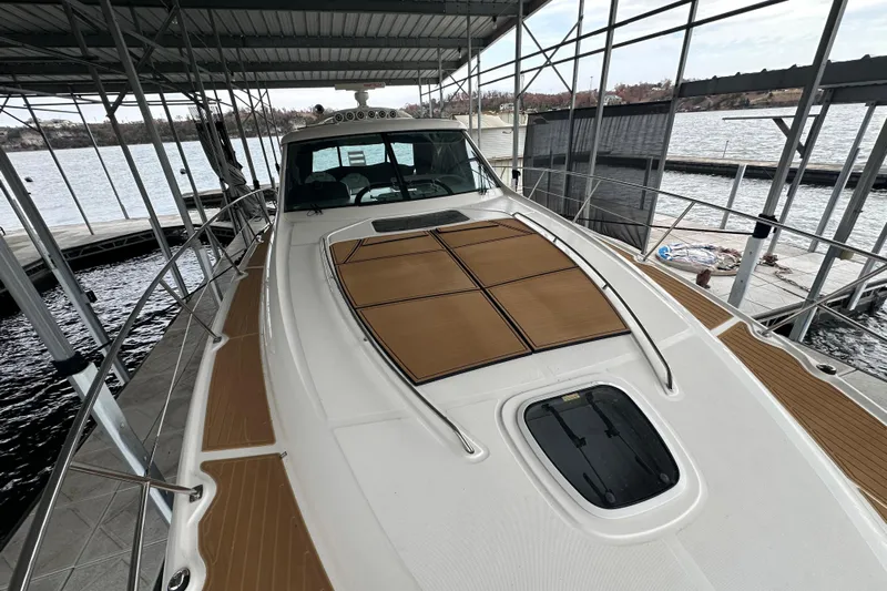  Yacht Photos Pics 2005 Sea Ray 48 Sundancer yacht docked under a covered marina, showcasing sleek design.