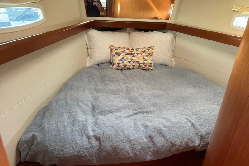 Eos Yacht Photos Pics Cozy cabin interior of 2008 Beneteau Oceanis 40 with comfortable bedding and decorative pillows.