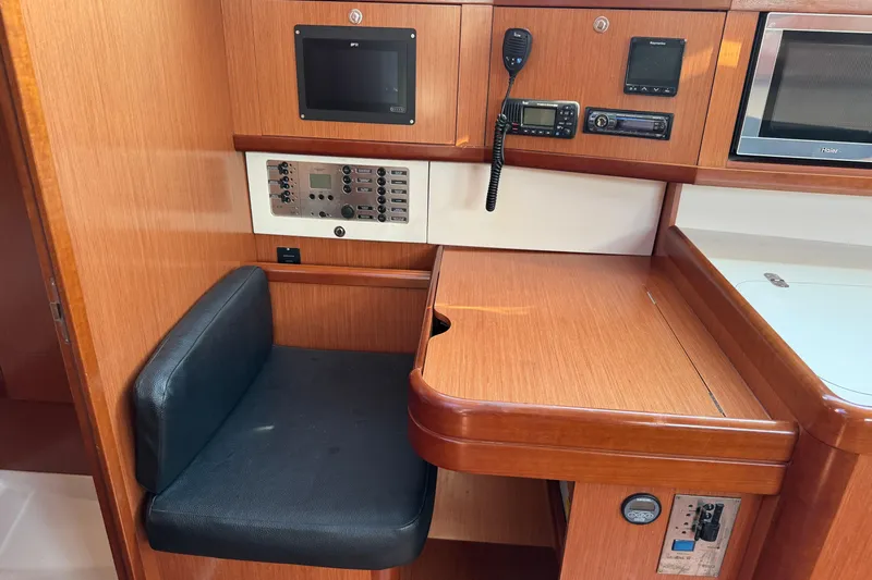 Eos Yacht Photos Pics Navigation station in 2008 Beneteau Oceanis 40 yacht with control panel and seating.