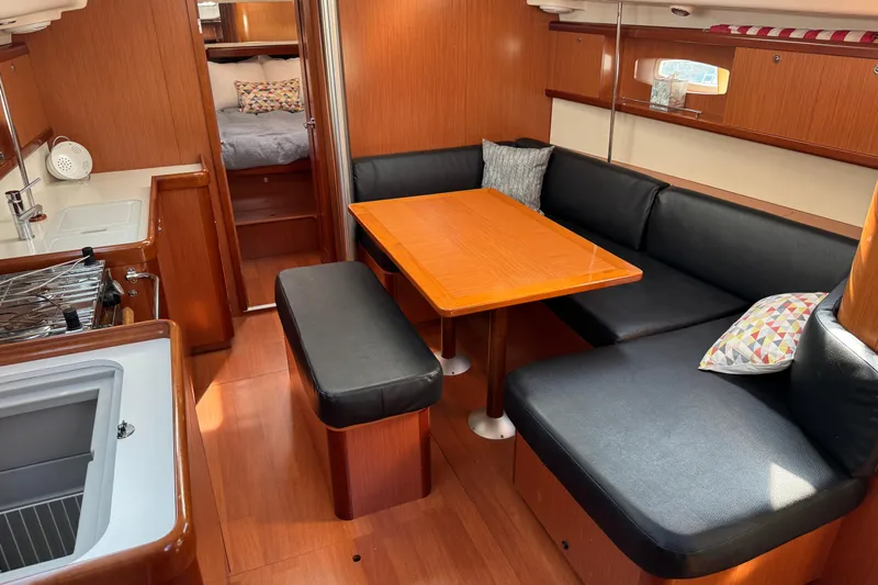 Eos Yacht Photos Pics Interior of 2008 Beneteau Oceanis 40 yacht with cozy seating and dining area.