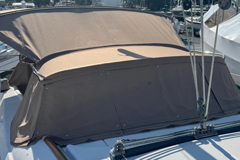 Eos Yacht Photos Pics 2008 Beneteau Oceanis 40 sailboat with beige canvas cover in marina.