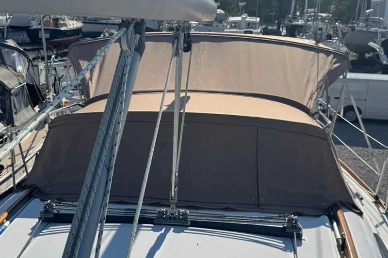 Eos Yacht Photos Pics 2008 Beneteau Oceanis 40 sailboat with beige canopy, docked in a marina.