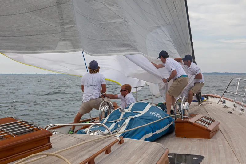 Bequia Yacht Photos Pics Crew adjusting sails on a 2009 Brooklin Boat Yard yacht in open water.