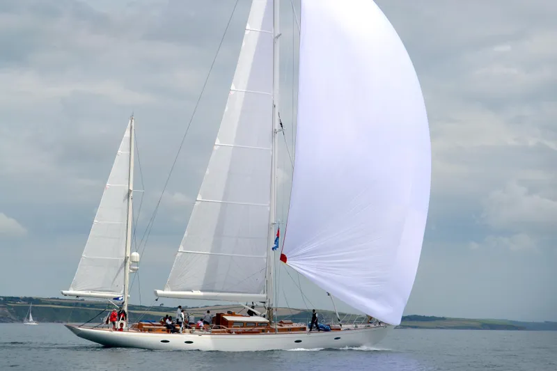 Bequia Yacht Photos Pics Sailing yacht by Brooklin Boat Yard, 2009 model, gliding on calm waters under a cloudy sky.