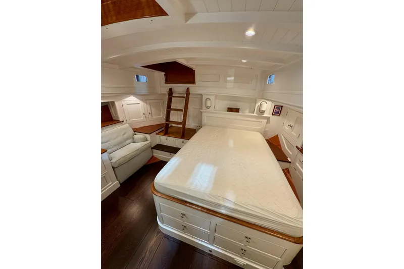 Bequia Yacht Photos Pics Luxurious 2009 Brooklin Boat Yard cabin interior with bed, seating, and wooden accents.