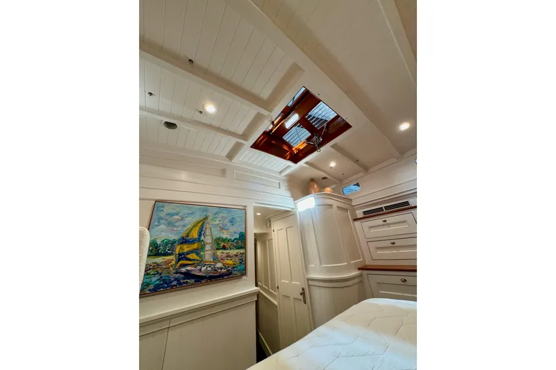 Bequia Yacht Photos Pics Luxurious 2009 Brooklin Boat Yard interior with elegant woodwork and vibrant sailboat painting.
