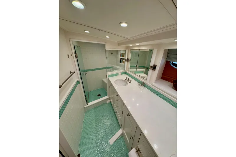 Bequia Yacht Photos Pics Luxurious boat bathroom with turquoise tiles, glass shower, and sleek white countertop, Brooklin Boat Yard 2009.