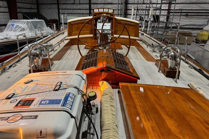 Bequia Yacht Photos Pics Luxurious 2009 Brooklin Boat Yard yacht interior with wooden deck and steering wheel.