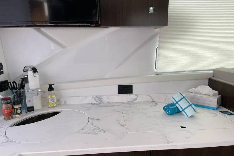  Yacht Photos Pics Modern kitchen area in 2022 Cruisers Yachts 42 Cantius with marble countertop.