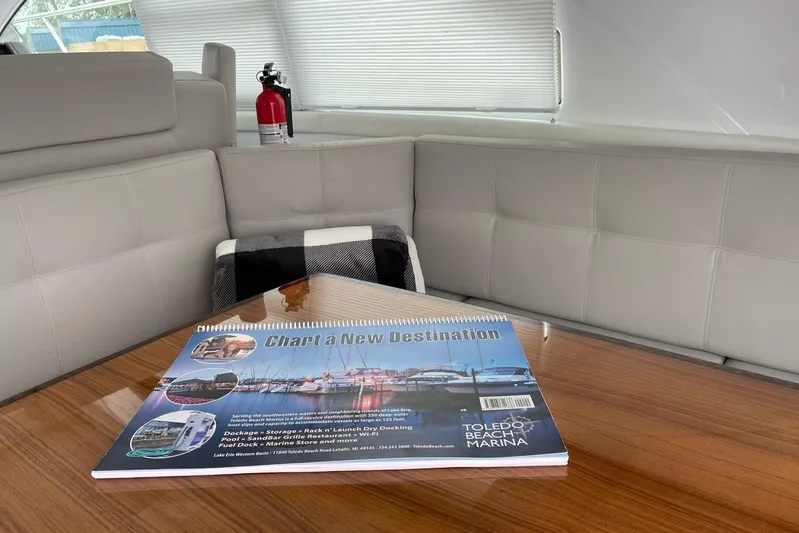  Yacht Photos Pics Interior of 2022 Cruisers Yachts 42 Cantius with brochure on table.