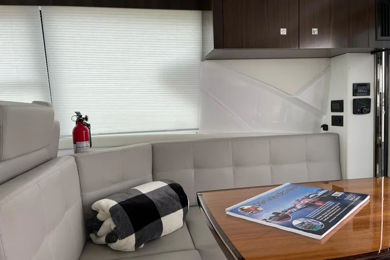  Yacht Photos Pics Interior of 2022 Cruisers Yachts 42 Cantius with sofa, table, and fire extinguisher.