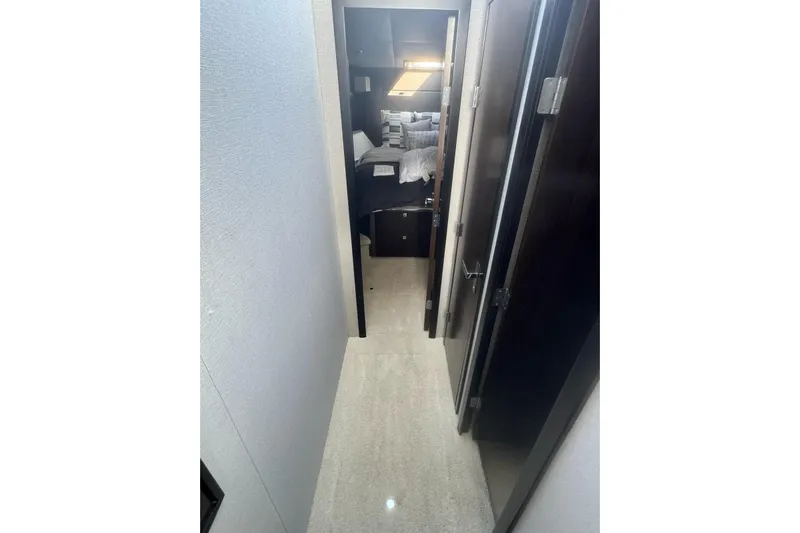  Yacht Photos Pics Interior hallway of 2022 Cruisers Yachts 42 Cantius, leading to a cozy bedroom.