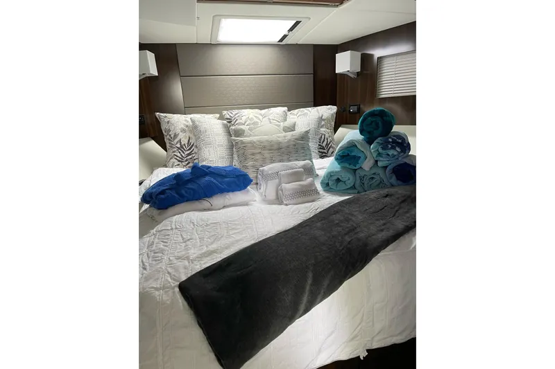  Yacht Photos Pics Luxurious bedroom in 2022 Cruisers Yachts 42 Cantius with plush bedding and towels.