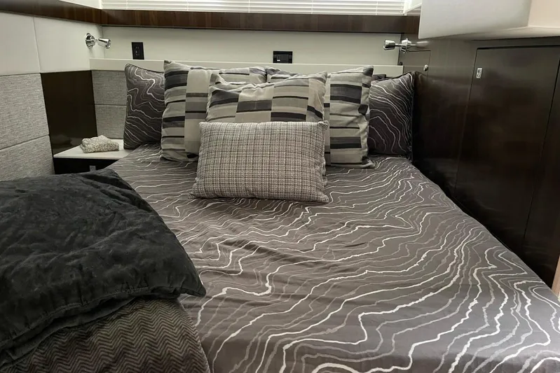  Yacht Photos Pics Luxurious bedroom interior of 2022 Cruisers Yachts 42 Cantius with stylish bedding.