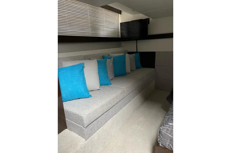  Yacht Photos Pics Interior of 2022 Cruisers Yachts 42 Cantius with gray sofa and blue cushions.