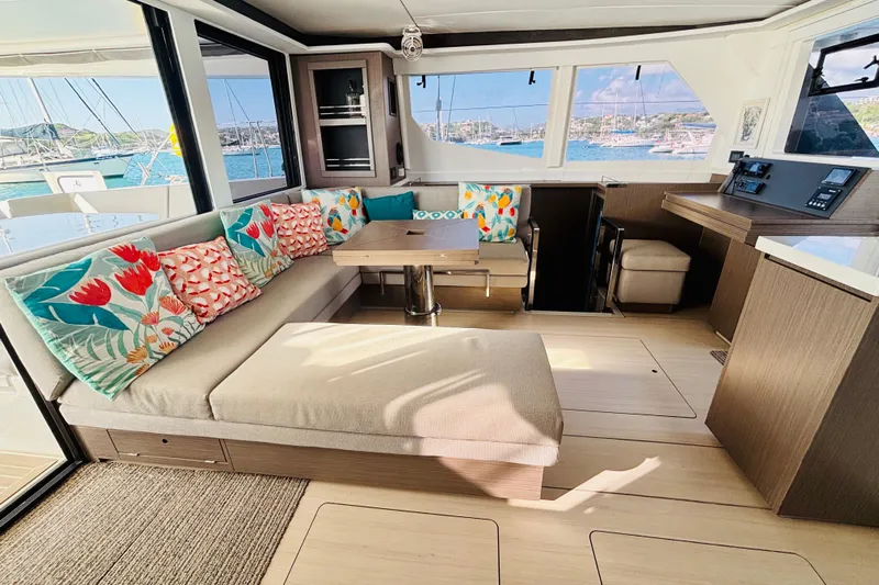 Yacht Photos Pics Luxurious interior of 2022 Leopard 45 yacht with colorful cushions and scenic ocean view.