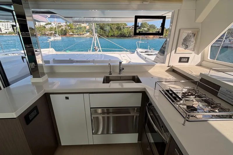  Yacht Photos Pics Modern kitchen on 2022 Leopard 45 yacht with ocean view and sleek appliances.