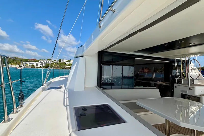  Yacht Photos Pics 2022 Leopard 45 yacht with sleek deck and modern interior, docked by turquoise waters.