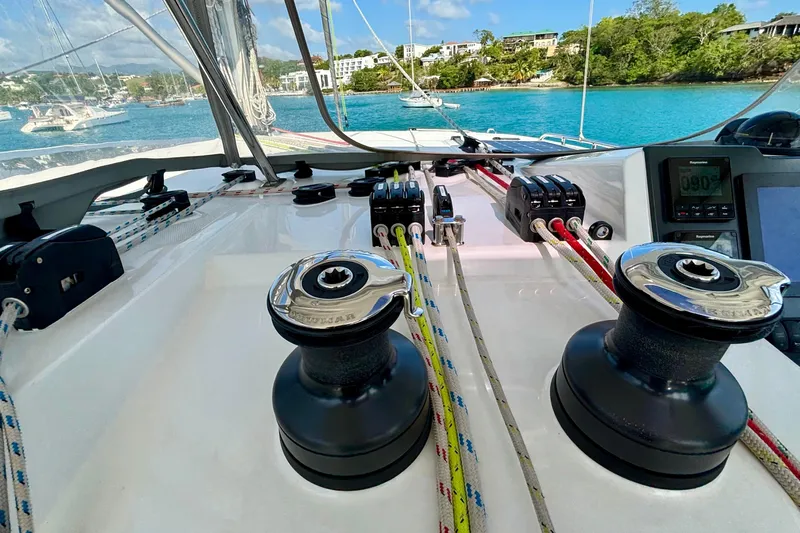  Yacht Photos Pics Sailing yacht Leopard 45 cockpit with winches and ropes, anchored in a scenic bay.