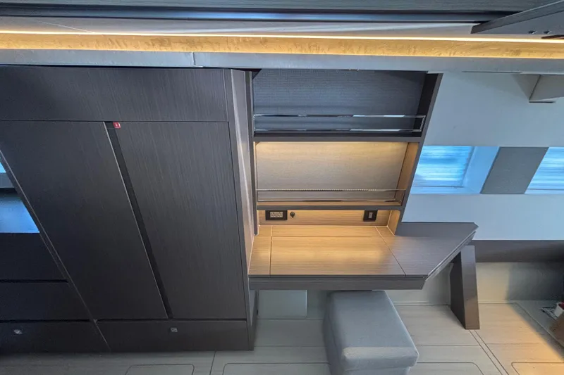  Yacht Photos Pics Modern interior of 2022 Leopard 45 yacht with sleek desk and ambient lighting.
