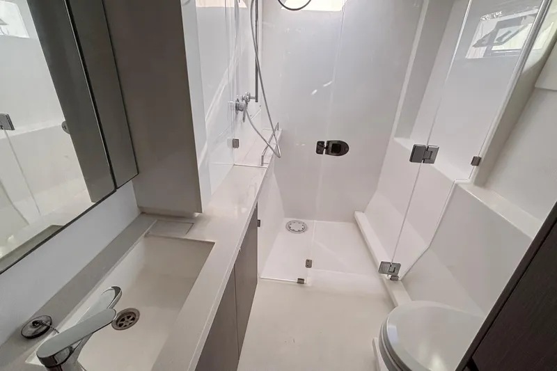  Yacht Photos Pics Modern bathroom in 2022 Leopard 45 yacht with shower, sink, and toilet.