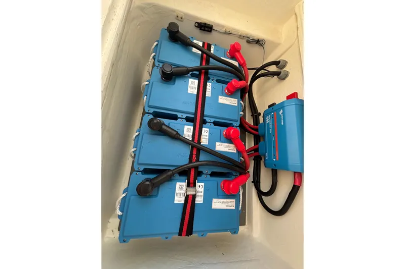  Yacht Photos Pics Battery setup in a 2022 Leopard 45 yacht, featuring blue lithium-ion batteries and wiring.
