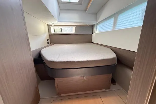  Yacht Photos Pics 2022 Leopard 45 yacht interior cabin with bed, modern design, and natural lighting.