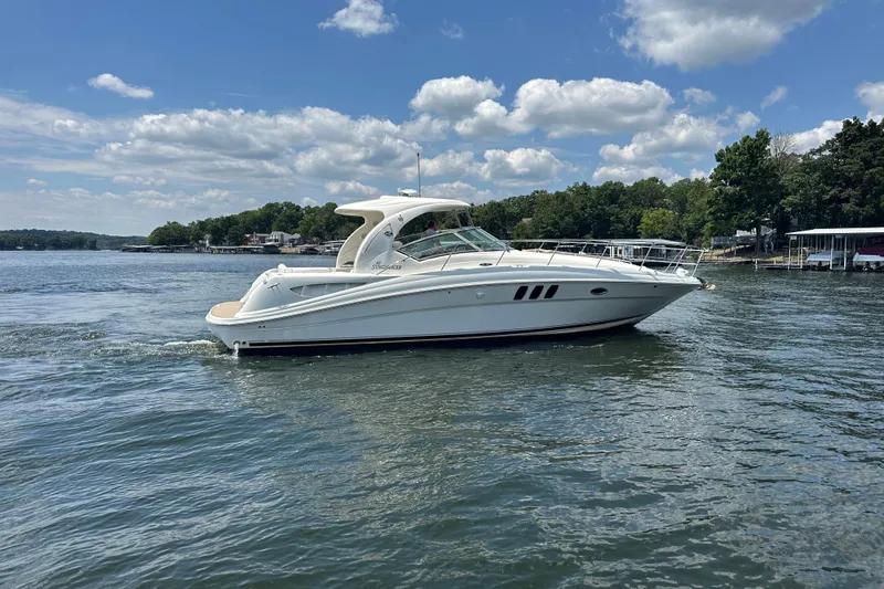  Yacht Photos Pics 2007 Sea Ray 40 Sundancer yacht cruising on a serene lake under a blue sky.