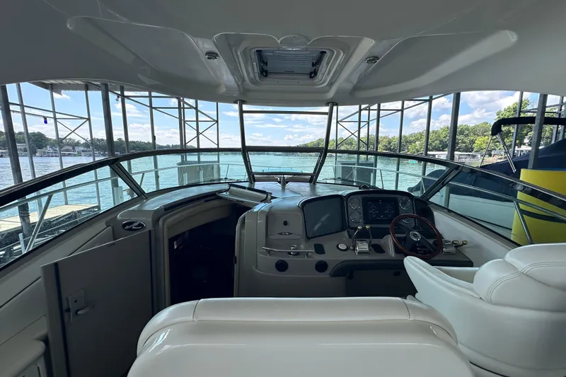 Yacht Photos Pics Interior view of 2007 Sea Ray 40 Sundancer yacht cockpit with scenic water backdrop.