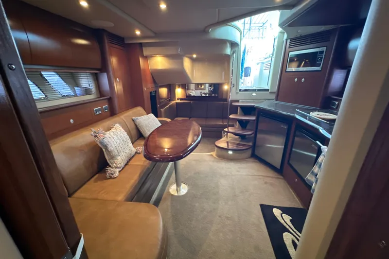  Yacht Photos Pics Luxurious interior of 2007 Sea Ray 40 Sundancer yacht with elegant seating and modern kitchen.