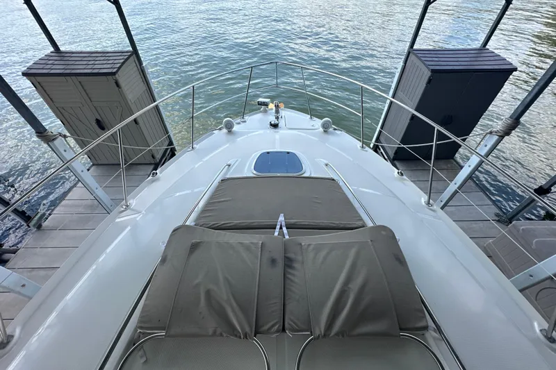  Yacht Photos Pics 2007 Sea Ray 40 Sundancer yacht bow view with sun pads and water backdrop.